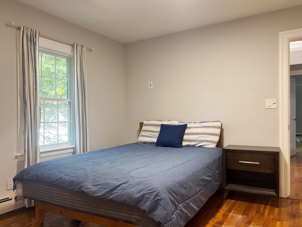 50 Dwhinda Road Newton, MA 02468 - Photo 31 of 42 a bedroom with a bed and wooden floor