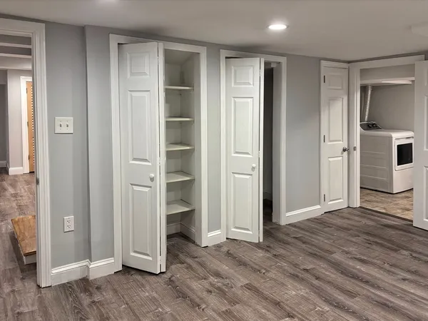 an empty room with closet and wooden floor