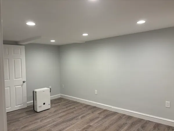 an empty room with wooden floor