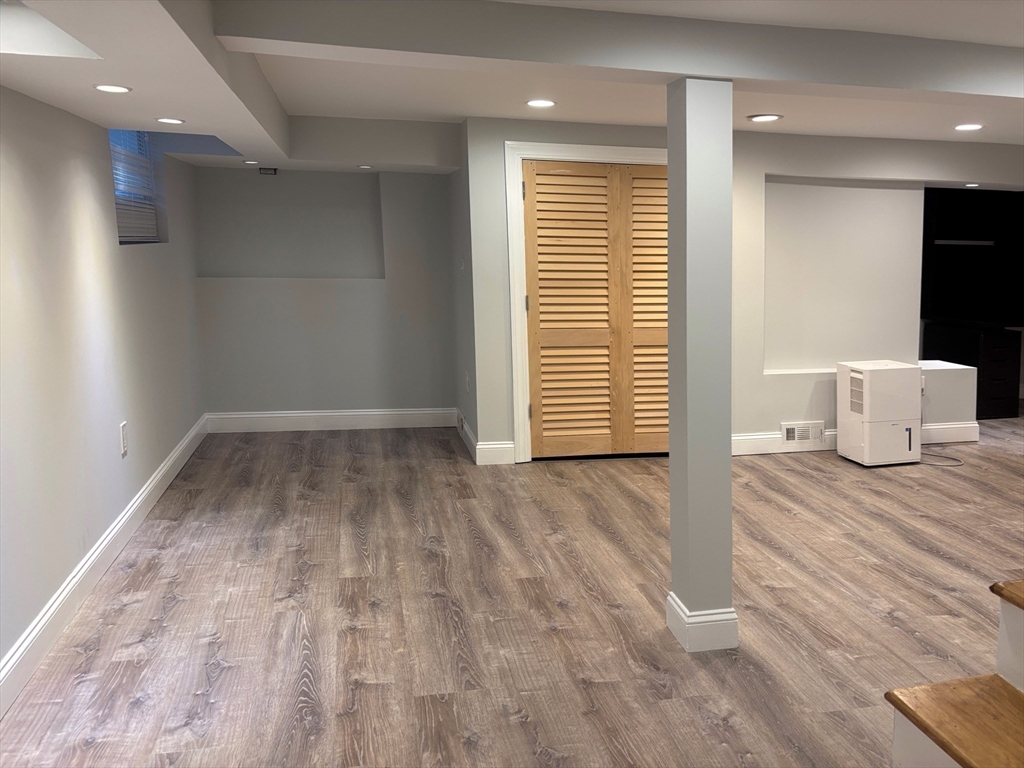 50 Dwhinda Road Newton, MA 02468 - Photo 37 of 42 wooden floor in an empty room with a window