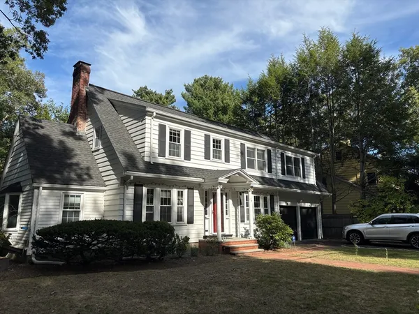 a front view of a house with a garden