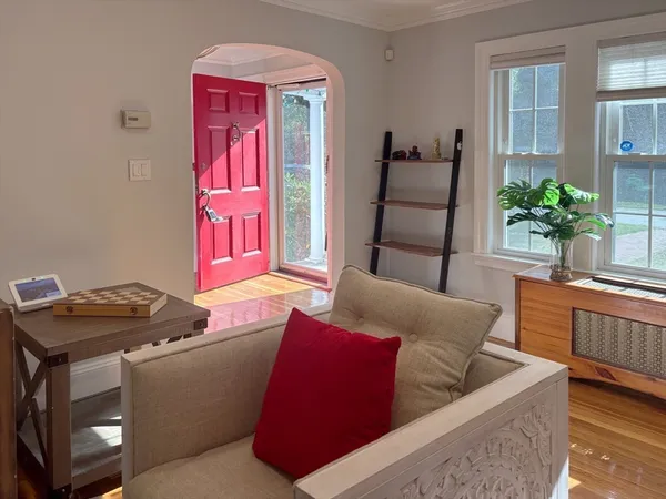 a living room with furniture and wooden floor