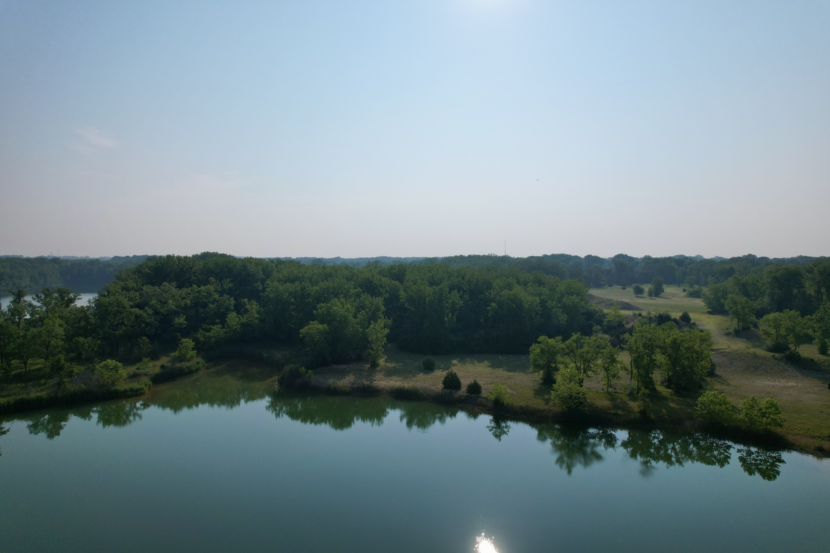 4141 East 2603rd Road Sheridan, IL 60551 - Photo 25 of 48 an aerial view of green landscape with trees houses and lake view