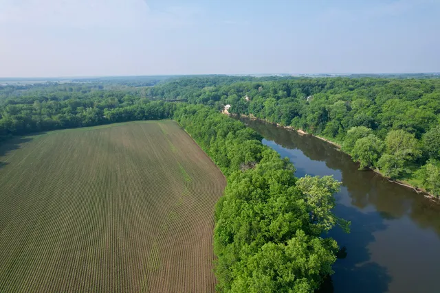 an aerial view of a house with a yard and lake view
