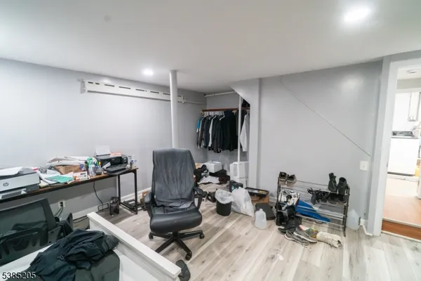a view of a workspace with furniture and a window
