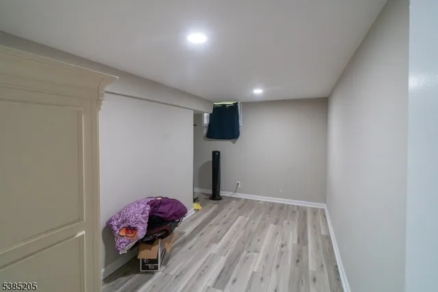 a view of room with wooden floor and entryway