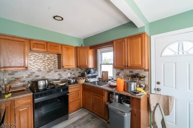 a kitchen with a sink stove top oven and cabinets