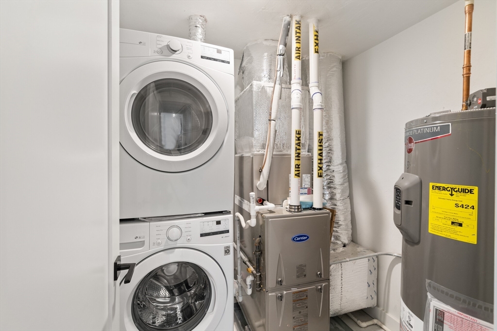 917 Bennington Street, Unit PH506 Boston, MA 02128 - Photo 8 of 11 a view of a room with washer and dryer
