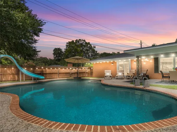 a view of a swimming pool with a patio