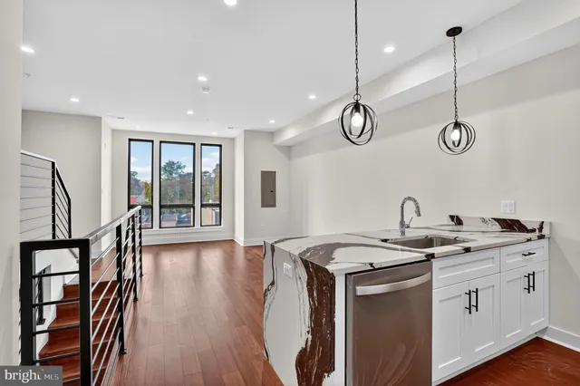 a view of kitchen with stainless steel appliances refrigerator microwave and stove