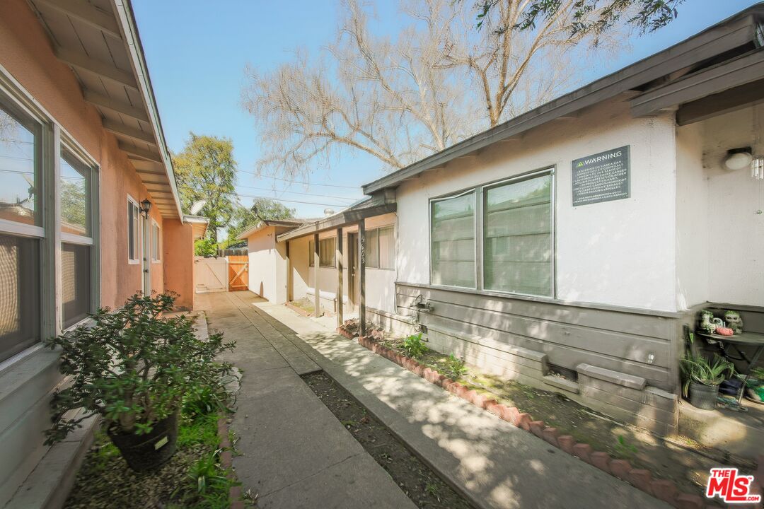 5663 Kester Avenue Van Nuys, CA 91411 - Photo 13 of 15 a view of a house with a yard