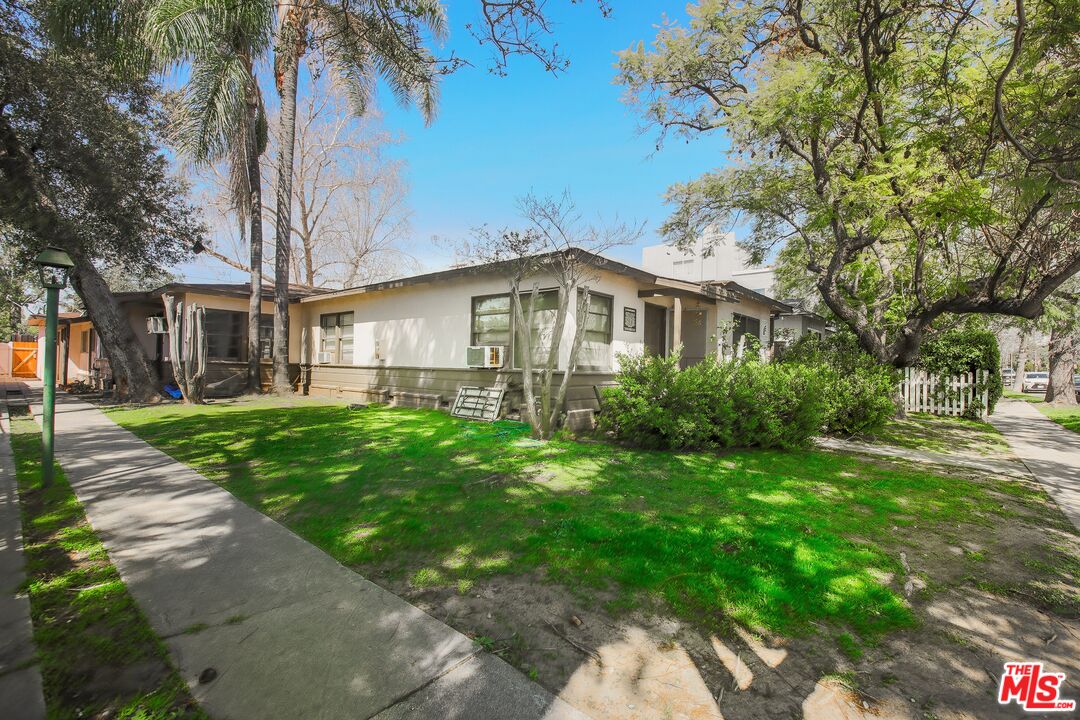 5663 Kester Avenue Van Nuys, CA 91411 - Photo 6 of 15 a front view of a house with garden