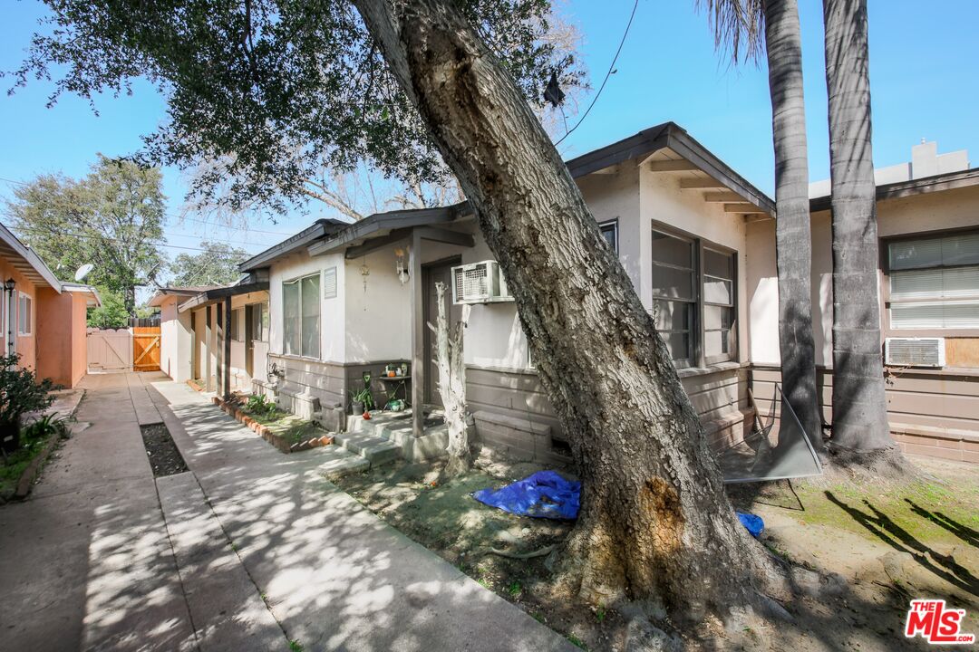 5663 Kester Avenue Van Nuys, CA 91411 - Photo 9 of 15 a front view of a house with a tree