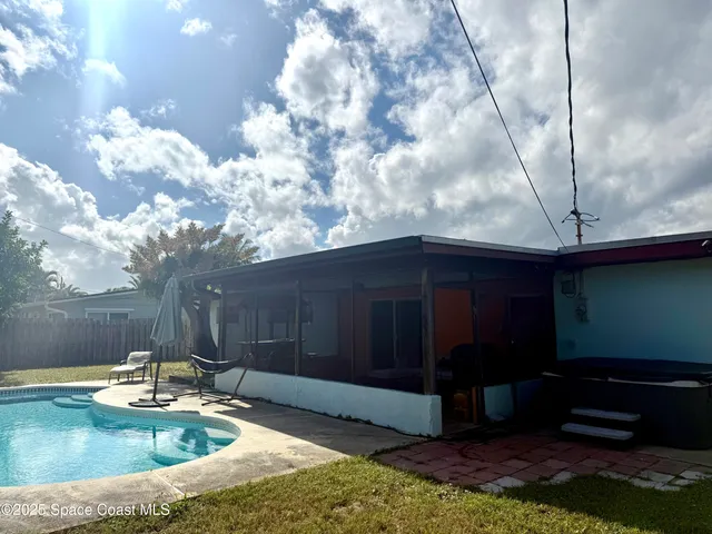 a view of a backyard with swimming pool