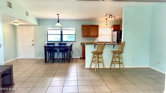 a dining room filled with furniture and window