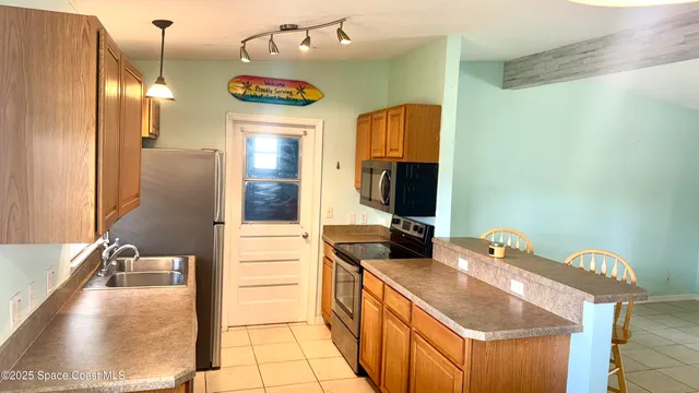 a bathroom with a granite countertop sink and a large mirror