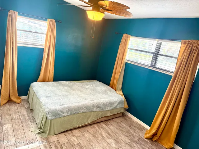 a bed sitting in a bedroom next to a window