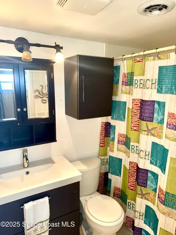 a bathroom with a sink a toilet and mirror