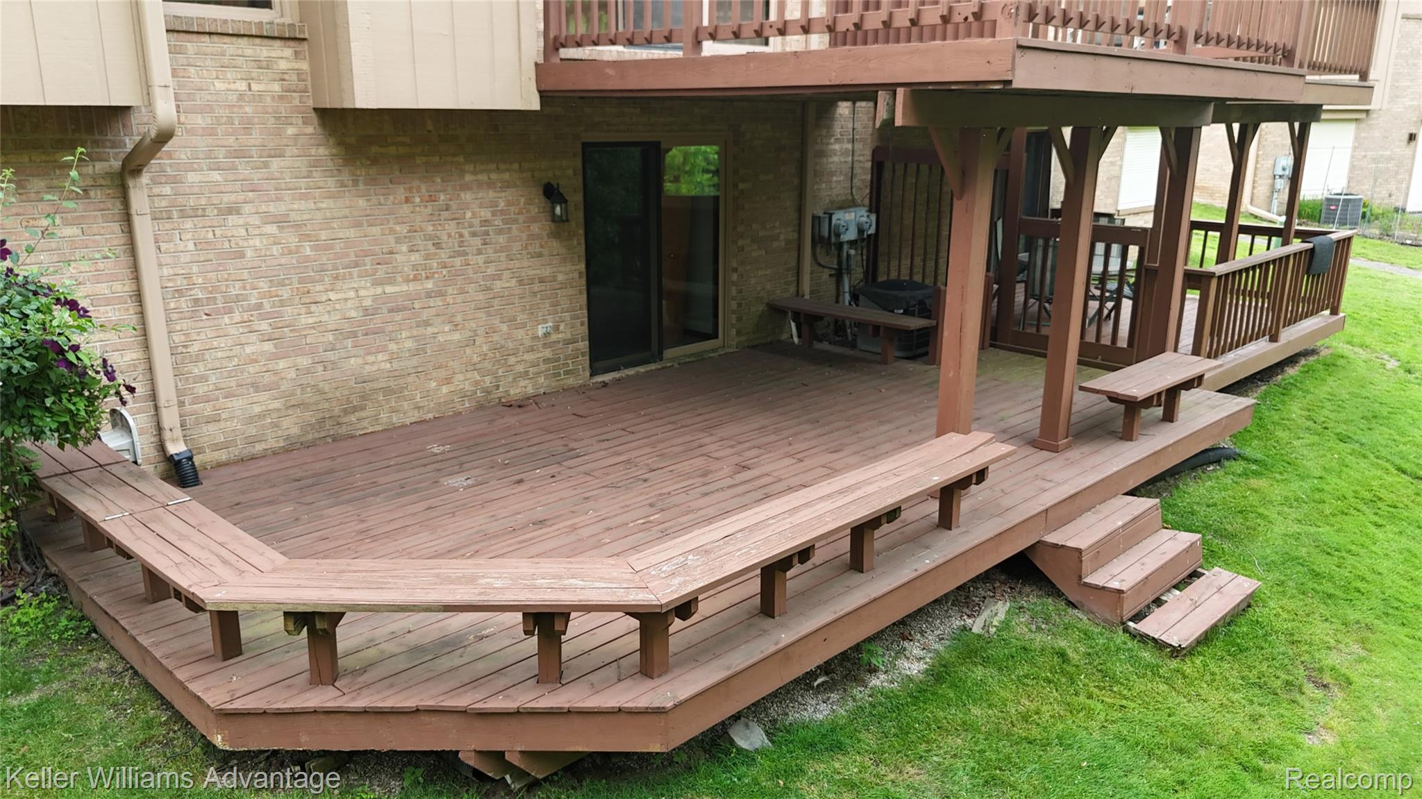 21850 River Ridge Trail Farmington, MI 48335 - Photo 30 of 33 Multi-level wood deck featuring built-in benches, partial overhead coverage, and a direct entry sliding glass door