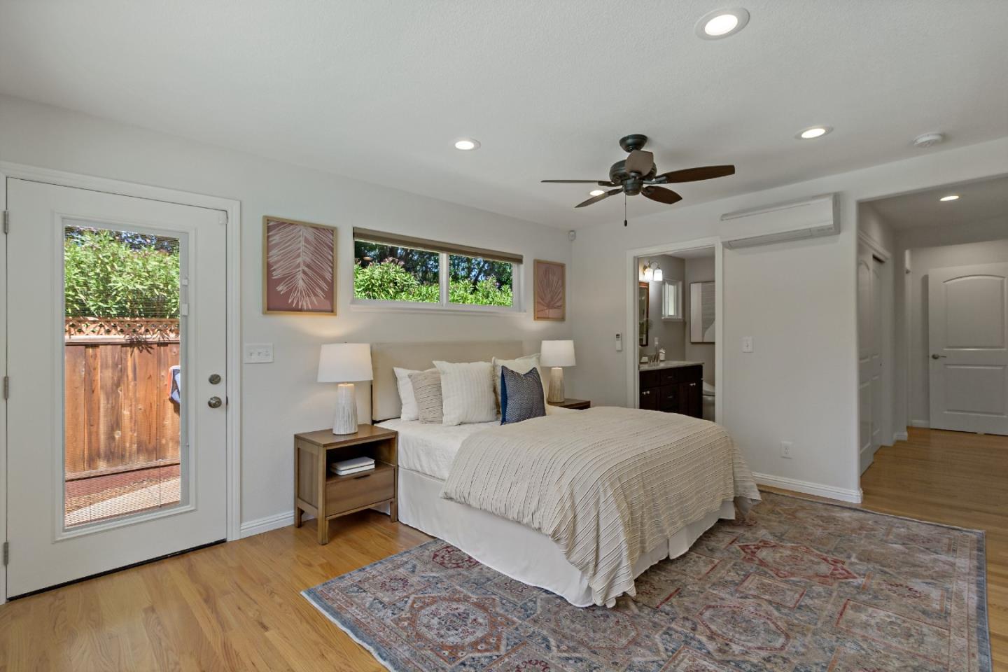 869 Terrace Drive Los Altos, CA 94024 - Photo 53 of 86 a bedroom with a large bed a chandelier and windows