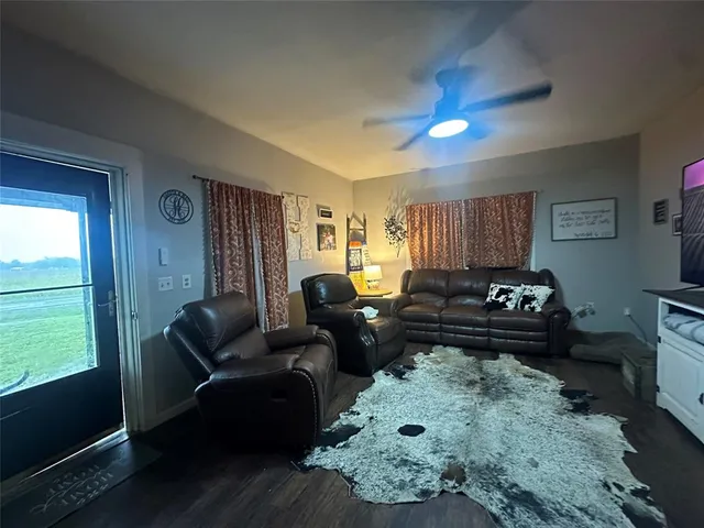 a living room with furniture fireplace and a window