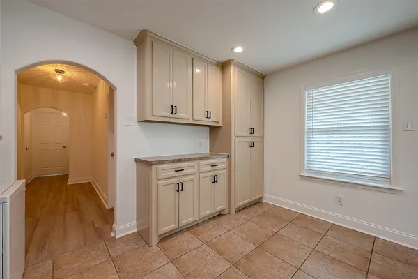 a view of a kitchen with fridge and front door