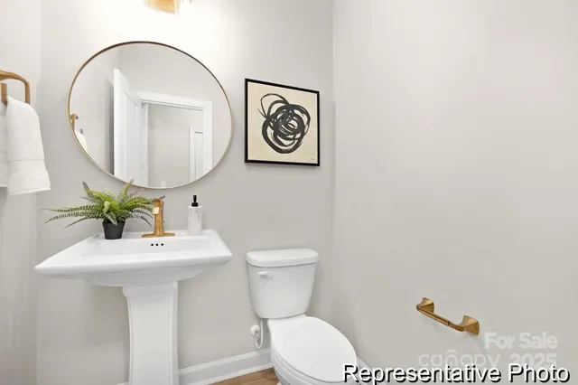 a bathroom with a toilet a sink and a mirror