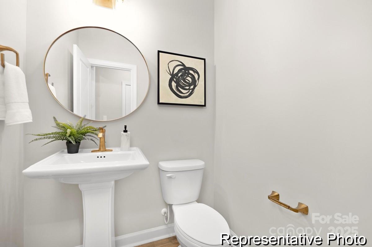 105 West Rice Planters Way, Unit 1P Statesville, NC 28625 - Photo 15 of 38 a bathroom with a toilet a sink and a mirror
