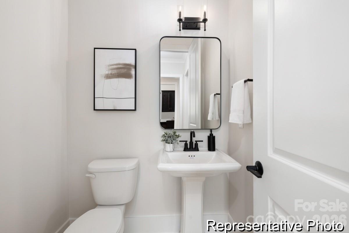 105 West Rice Planters Way, Unit 1P Statesville, NC 28625 - Photo 16 of 41 a bathroom with a toilet sink and mirror