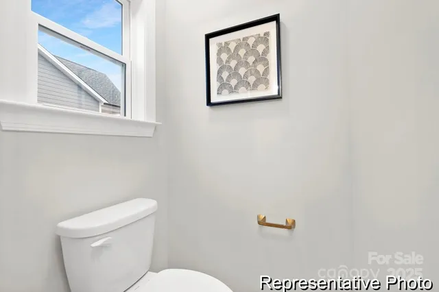 a white toilet sitting next to a bathroom sink