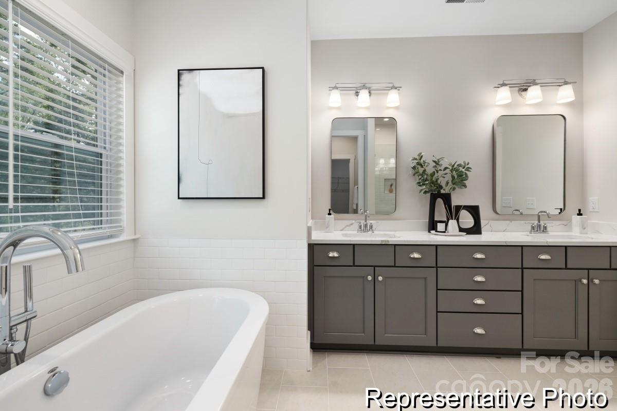 105 West Rice Planters Way, Unit 1P Statesville, NC 28625 - Photo 28 of 41 a bathroom with a tub sink and mirror