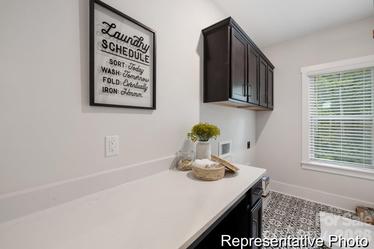 105 West Rice Planters Way, Unit 1P Statesville, NC 28625 - Photo 32 of 41 a kitchen with stainless steel appliances a sink a stove and a refrigerator