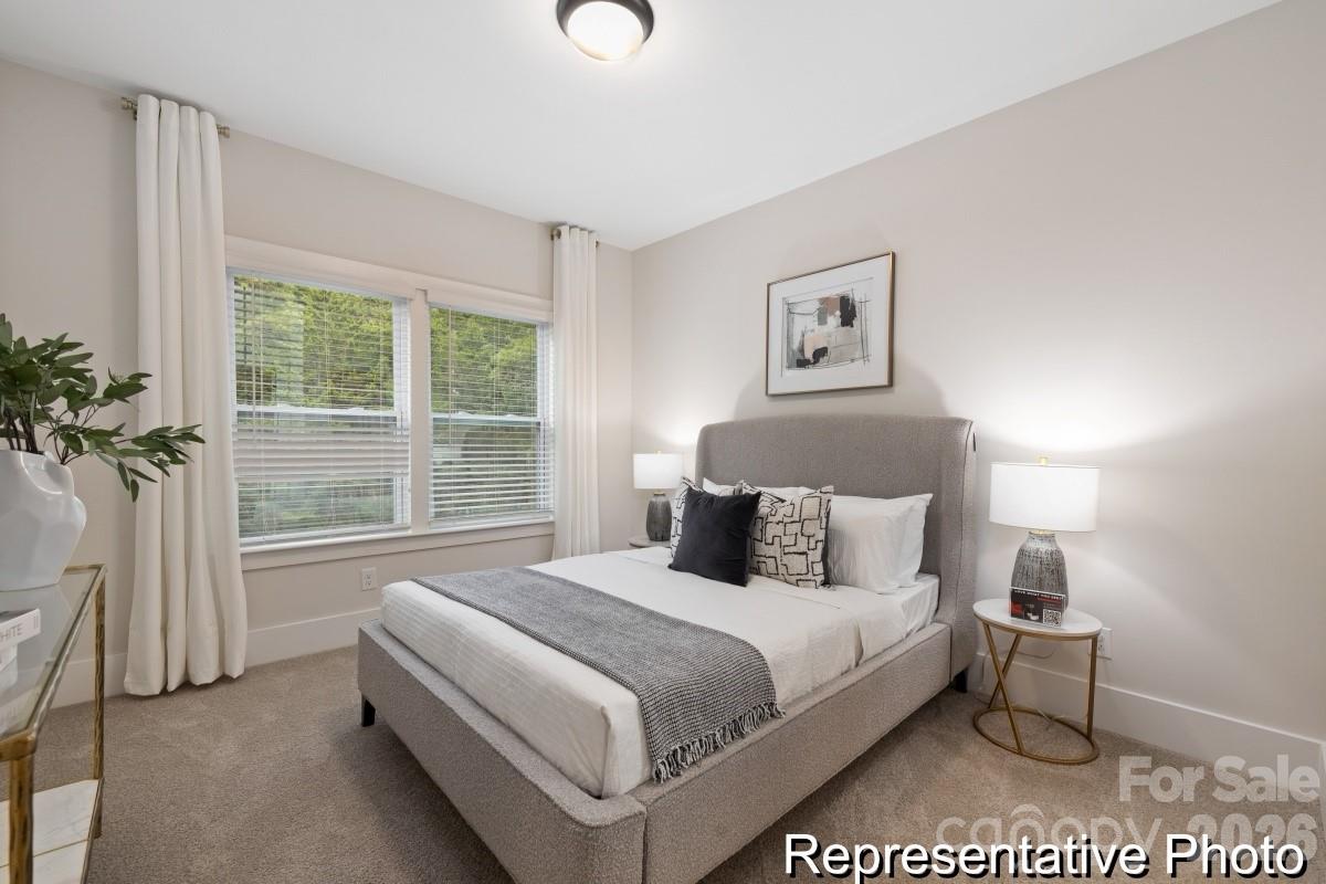 105 West Rice Planters Way, Unit 1P Statesville, NC 28625 - Photo 33 of 41 a bedroom with a bed and a large window