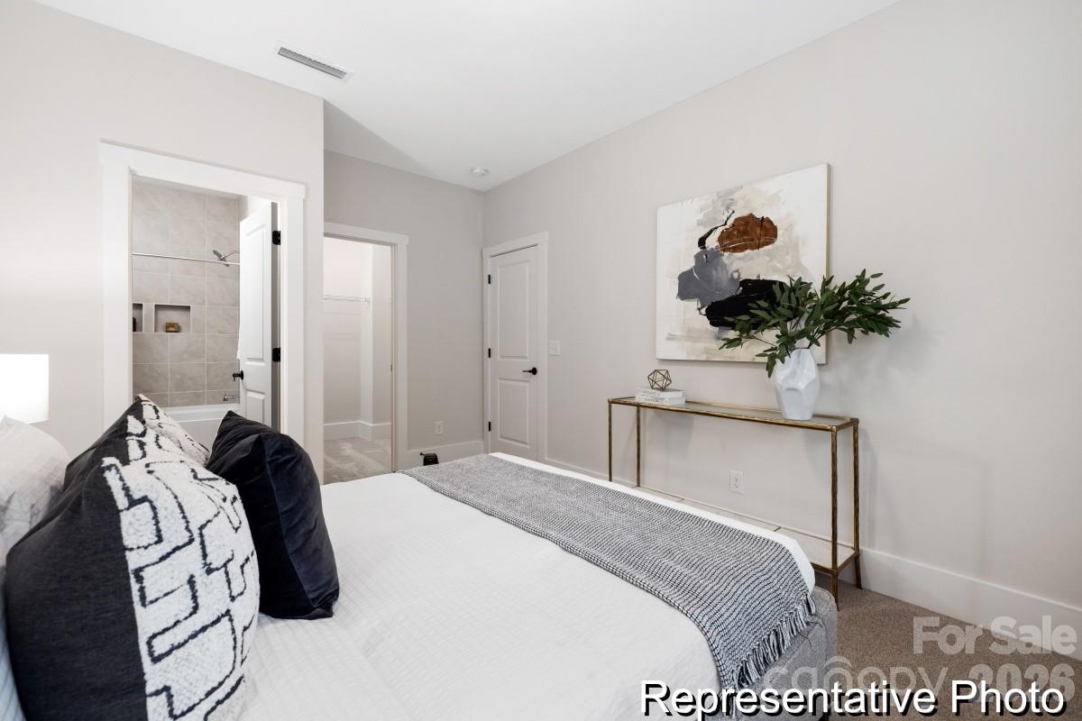 105 West Rice Planters Way, Unit 1P Statesville, NC 28625 - Photo 34 of 41 a bedroom with a bed and a potted plant