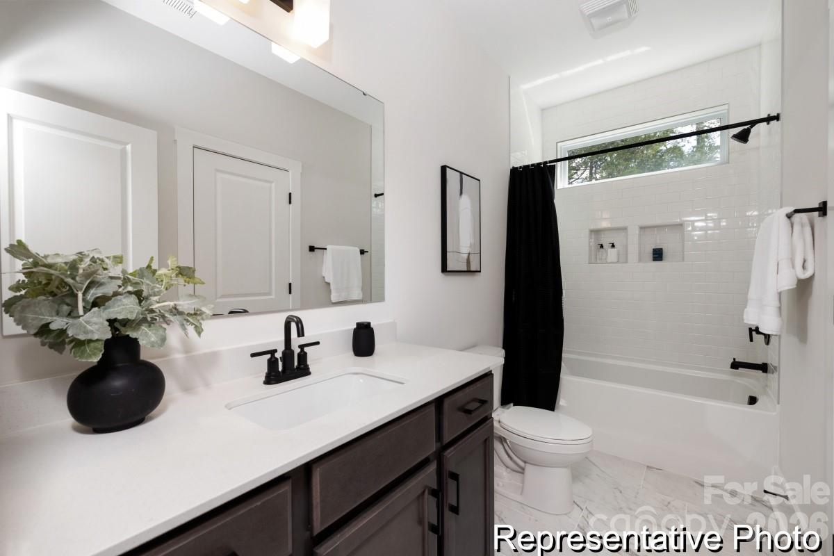 105 West Rice Planters Way, Unit 1P Statesville, NC 28625 - Photo 36 of 41 a bathroom with a sink a toilet and shower