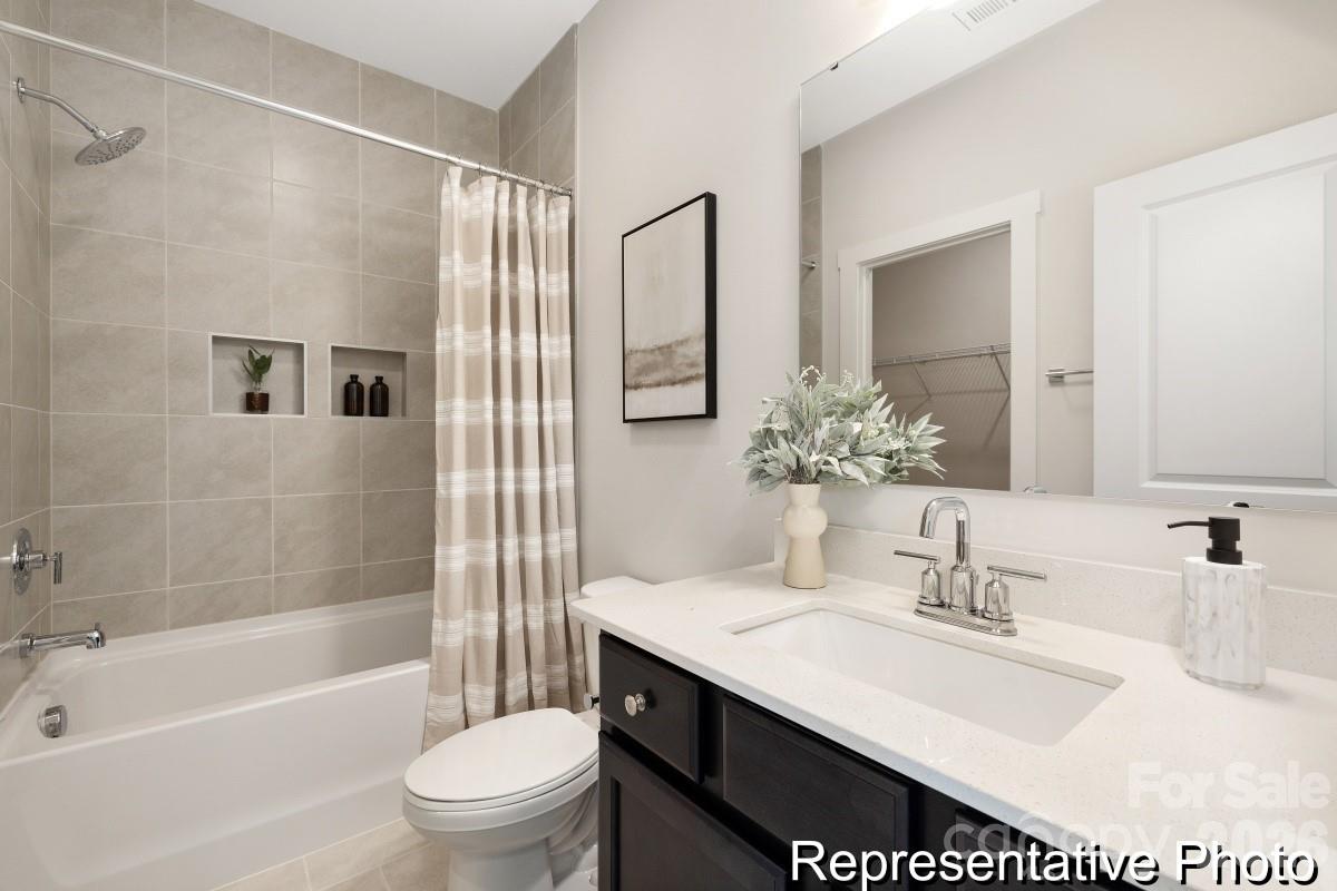 105 West Rice Planters Way, Unit 1P Statesville, NC 28625 - Photo 39 of 41 a bathroom with a sink a toilet and shower