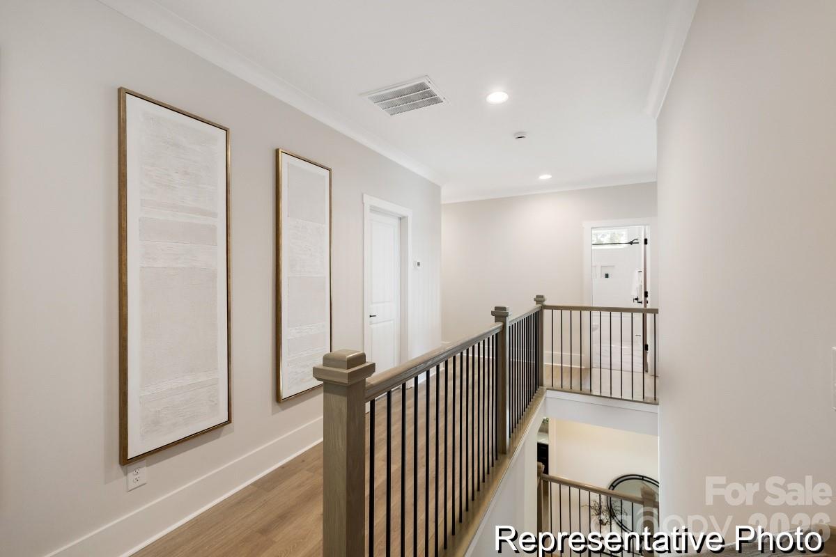 105 West Rice Planters Way, Unit 1P Statesville, NC 28625 - Photo 40 of 41 a view of a hallway with wooden floor and windows