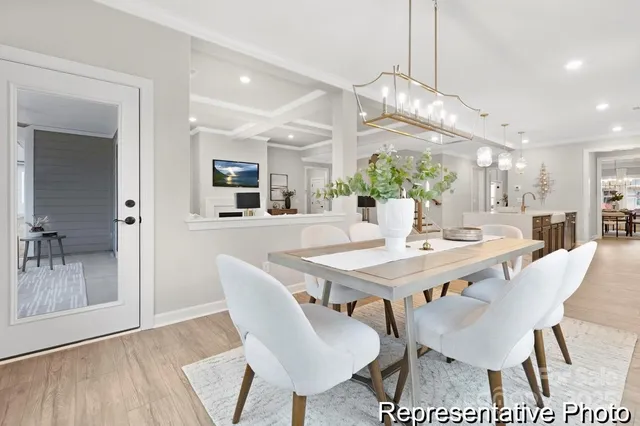 a view of a dining room with furniture and a chandelier