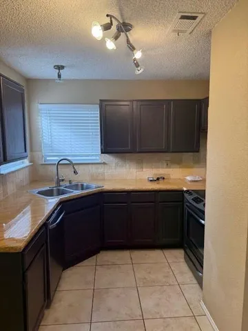 a kitchen with stainless steel appliances granite countertop a sink and cabinets