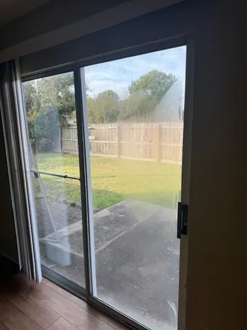 a view of a glass door with wooden floor