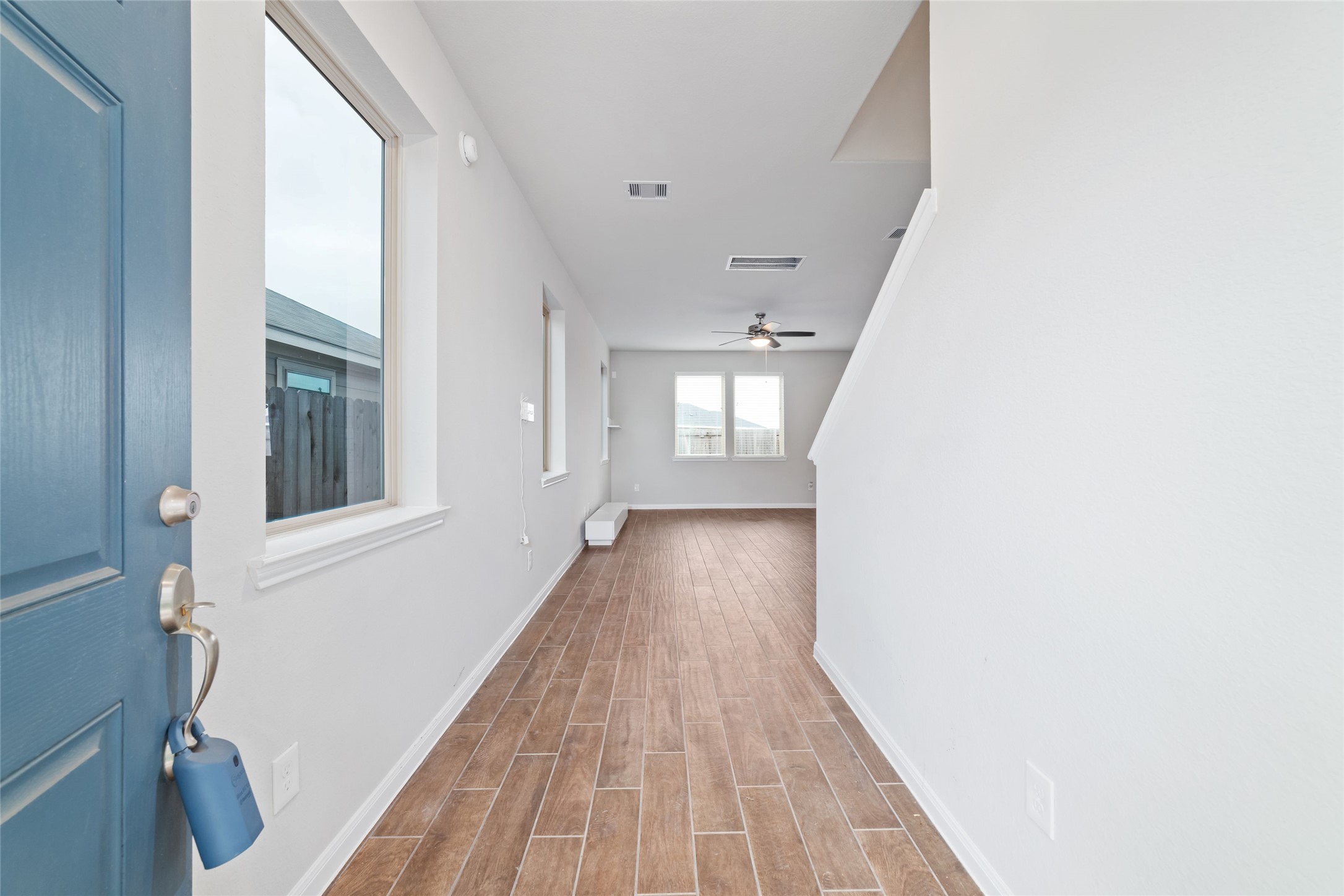 21622 Buttonsage Lane Katy, TX 77449 - Photo 5 of 17 a view of a hallway with wooden floor and a bathroom