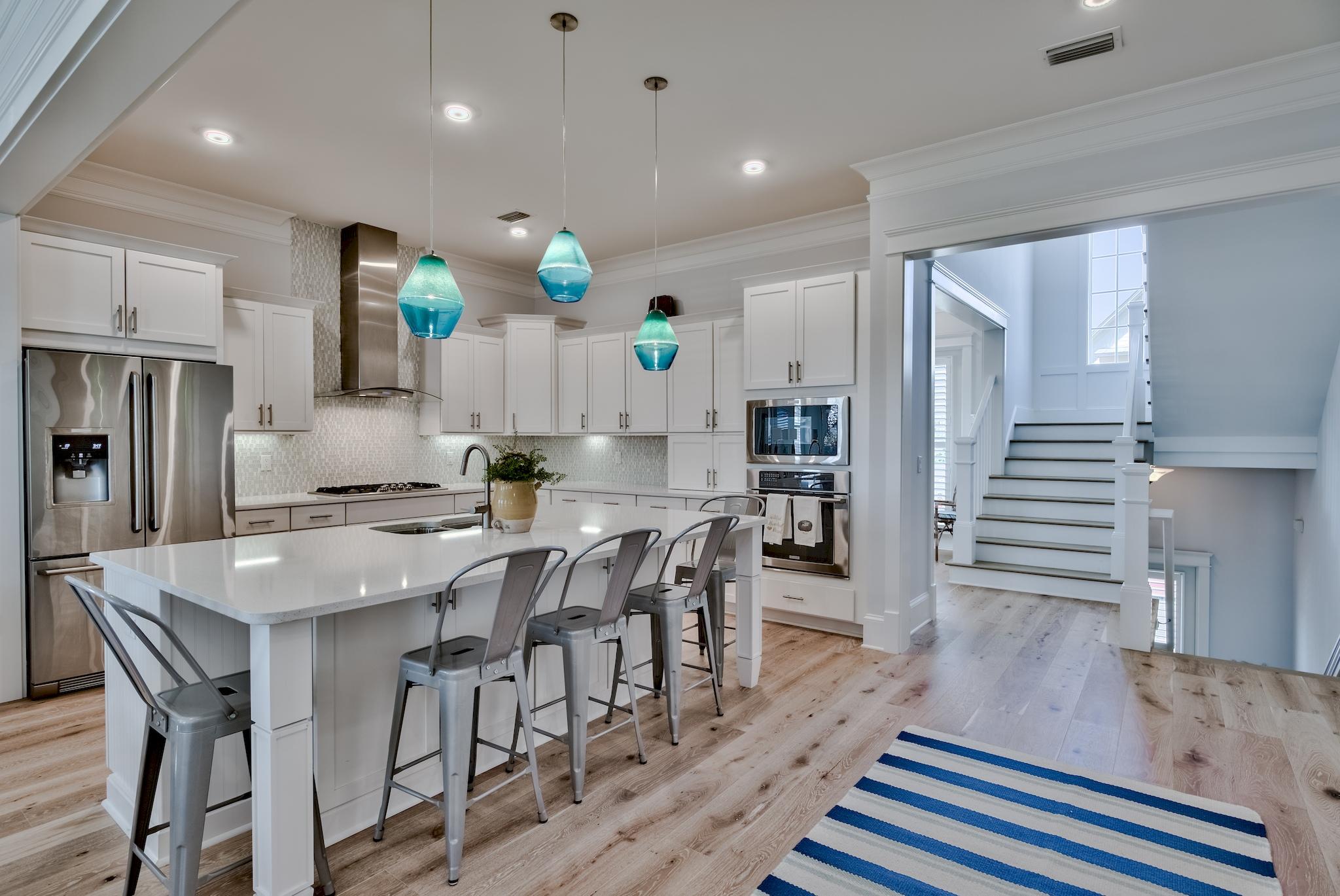 114 Clipper Street Inlet Beach, FL 32461 - Photo 1 of 64 a large kitchen with cabinets chairs and wooden floor