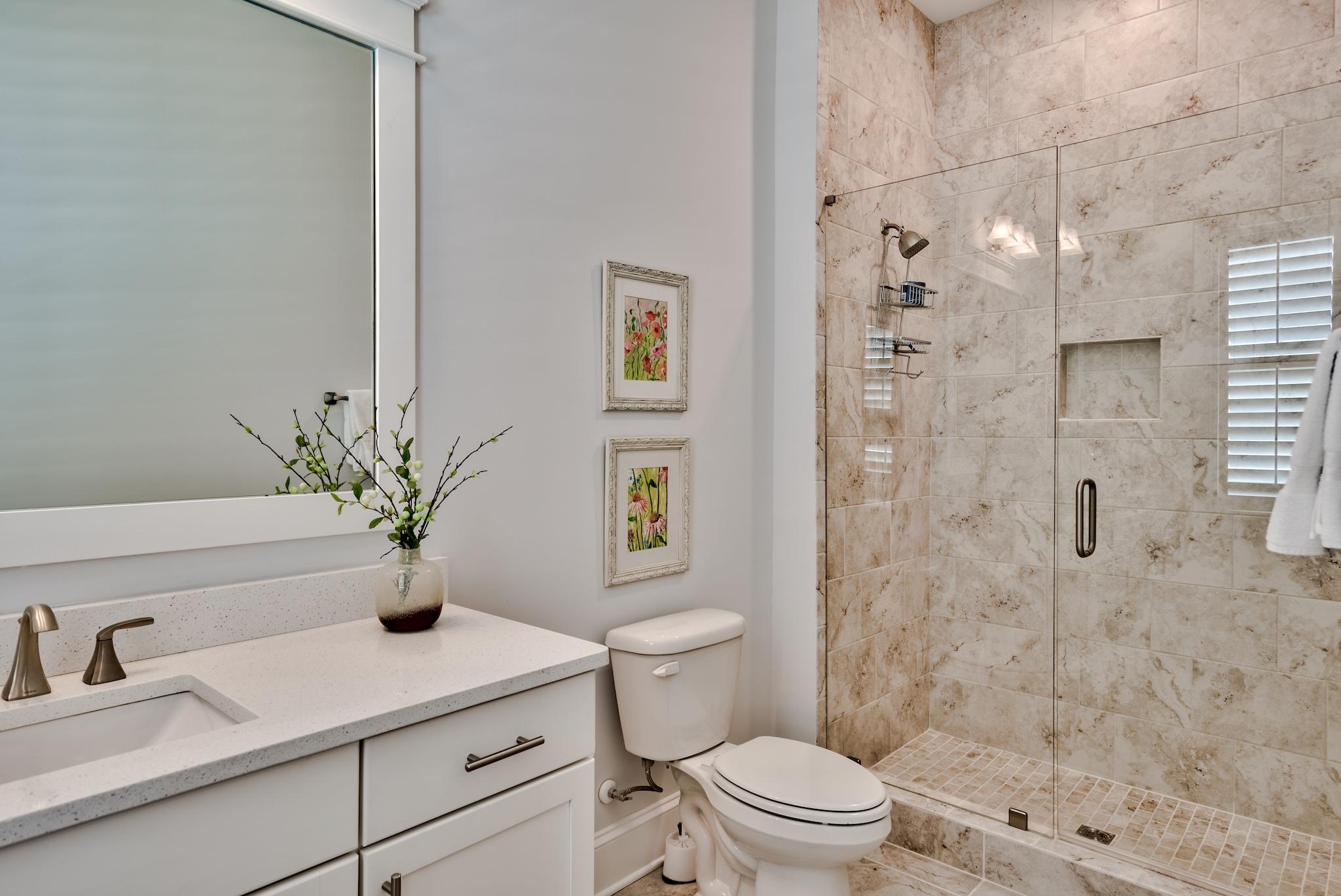 114 Clipper Street Inlet Beach, FL 32461 - Photo 28 of 64 a bathroom with a sink a toilet a glass door a shower and a mirror