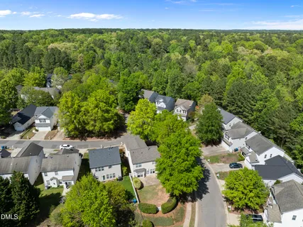 an aerial view of a house with a yard