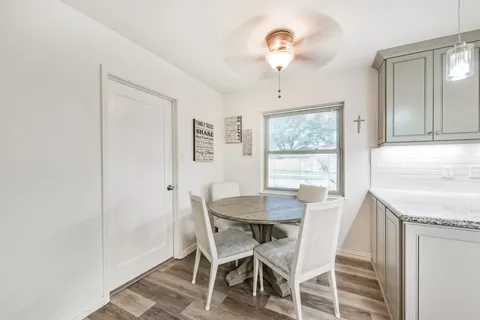 a view of a dining room with furniture and a chandelier