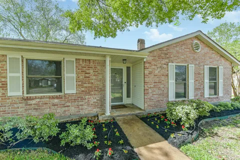front view of a brick house with a large windows
