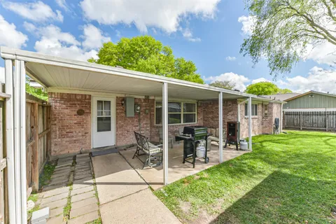 a view of a house with backyard sitting area and garden