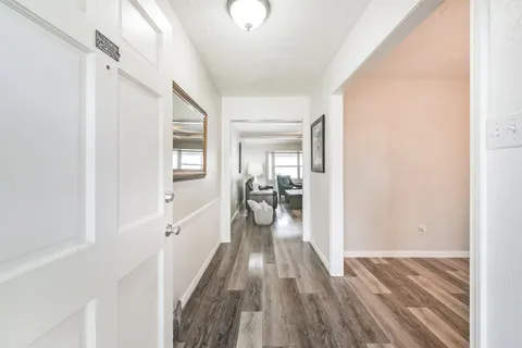 a view of hallway with wooden floor