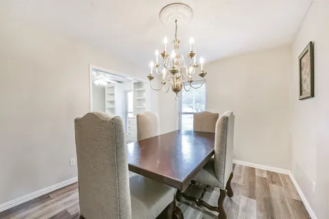 a view of a dining room with furniture and chandelier