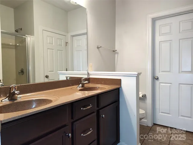 a bathroom with a glass shower door